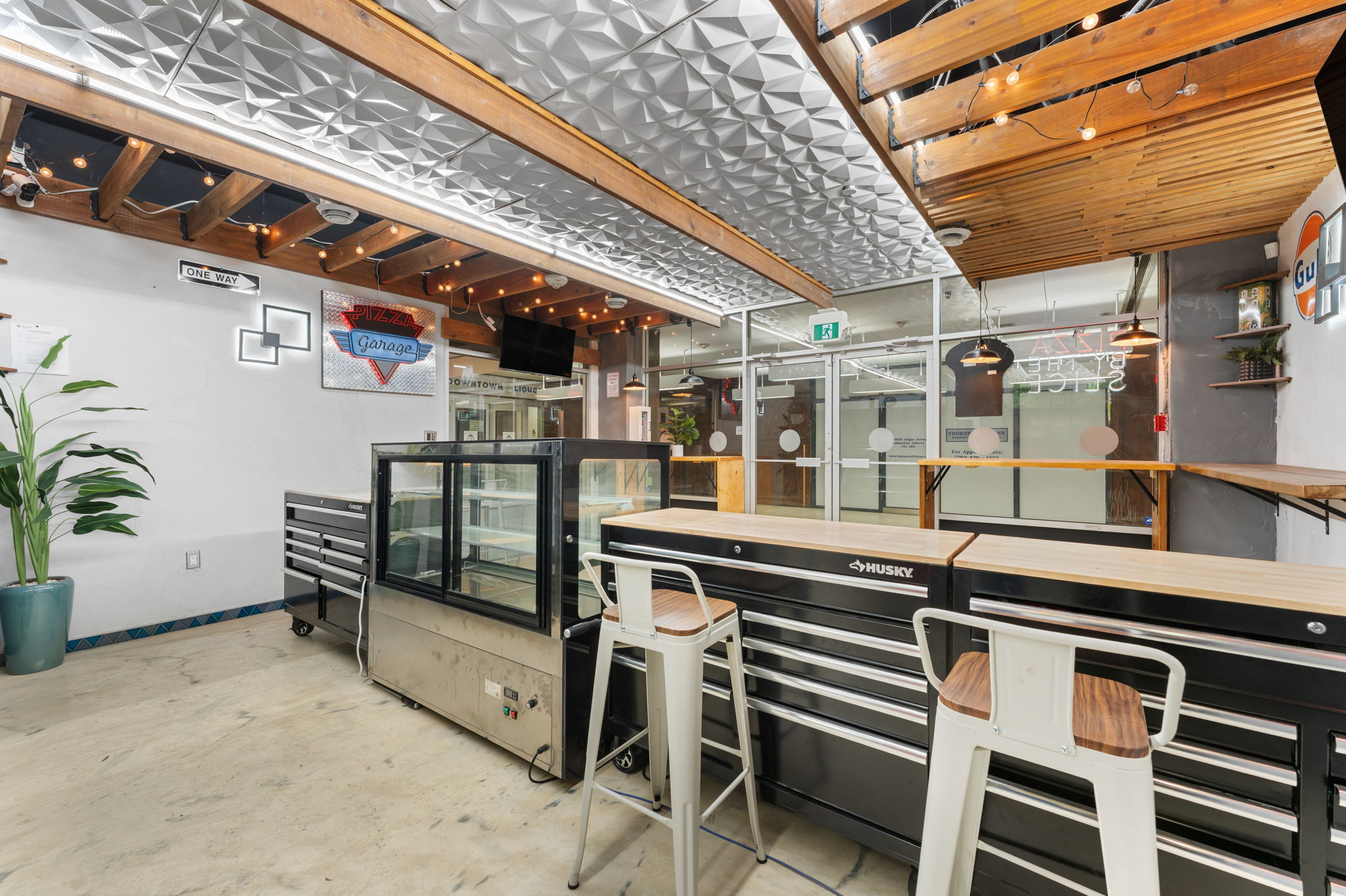 Modern hospitality interior with timber ceiling and bar seating